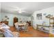Bright dining area featuring a round table with seating, wood floors and a ceiling fan for a cozy atmosphere at 10989 Sw 86Th Ave, Ocala, FL 34481