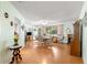 Bright dining area with wood floors, a round table, and a view to the entry door at 10989 Sw 86Th Ave, Ocala, FL 34481