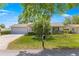 Beautiful single-story home with a two-car garage, manicured lawn, and lovely landscaping at 10989 Sw 86Th Ave, Ocala, FL 34481
