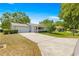 Single-story home boasts a large driveway, mature trees and welcoming front porch at 10989 Sw 86Th Ave, Ocala, FL 34481