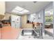 Bright kitchen featuring white appliances, wood floors, and ample counter space with a double sink at 10989 Sw 86Th Ave, Ocala, FL 34481