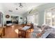 Living room with a vaulted ceiling, a ceiling fan, lots of windows and an open floorplan at 10989 Sw 86Th Ave, Ocala, FL 34481