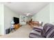 Cozy living room with carpeted floors, comfortable seating, and a large window offering natural light at 10989 Sw 86Th Ave, Ocala, FL 34481