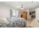 Bright main bedroom features wood flooring, ceiling fan, and an adjacent closet offering a serene space at 10989 Sw 86Th Ave, Ocala, FL 34481