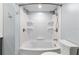 Bright bathroom featuring a dual shower head, bathtub, and built in storage shelving at 11065 Ne 42Nd St, Silver Springs, FL 34488