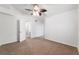 Bedroom featuring neutral carpet, ceiling fan and white walls at 11065 Ne 42Nd St, Silver Springs, FL 34488