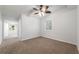 Bedroom featuring neutral carpet, ceiling fan and white walls at 11065 Ne 42Nd St, Silver Springs, FL 34488