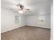Well-lit bedroom with carpet flooring and two windows at 11065 Ne 42Nd St, Silver Springs, FL 34488