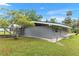 Charming exterior view of the home featuring well-maintained lawn and mature landscaping at 11065 Ne 42Nd St, Silver Springs, FL 34488