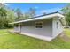 Exterior of the home featuring a well-kept lawn and covered entry way at 11065 Ne 42Nd St, Silver Springs, FL 34488