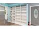 Hallway features a custom built in shelving unit for storage near the front door at 11065 Ne 42Nd St, Silver Springs, FL 34488