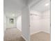 Hallway with open walk-in closet, neutral carpet and white walls at 11065 Ne 42Nd St, Silver Springs, FL 34488
