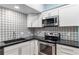 The kitchen features granite countertops, stainless appliances, and a stylish backsplash at 11065 Ne 42Nd St, Silver Springs, FL 34488