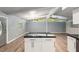 Spacious living room with vaulted ceilings, modern island, and access to kitchen at 11065 Ne 42Nd St, Silver Springs, FL 34488