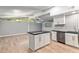 Spacious living room with vaulted ceilings, modern island, and updated kitchen at 11065 Ne 42Nd St, Silver Springs, FL 34488