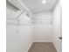 Walk-in closet with shelving unit and neutral carpet at 11065 Ne 42Nd St, Silver Springs, FL 34488
