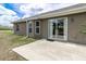 Exterior of the home, showcasing the sliding glass door leading to the backyard at 13645 Se 42 Ave, Summerfield, FL 34491