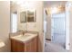 Bathroom view highlighting the vanity, mirror, and doorway to a bedroom at 13645 Se 42 Ave, Summerfield, FL 34491