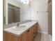 Bathroom featuring a double sink vanity and tiled shower at 13645 Se 42 Ave, Summerfield, FL 34491