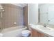Neutral bathroom featuring tile shower over tub combo and a single sink vanity at 13645 Se 42 Ave, Summerfield, FL 34491
