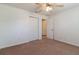 A bedroom with ceiling fan, closet, and entrance to the bathroom at 13645 Se 42 Ave, Summerfield, FL 34491