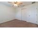 A secondary bedroom is carpeted and has a ceiling fan and double door closet at 13645 Se 42 Ave, Summerfield, FL 34491