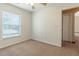 Well-lit bedroom with a large window, neutral carpet, and walls, creating a serene space at 13645 Se 42 Ave, Summerfield, FL 34491