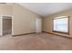 Carpeted bedroom with natural light, a window, and a ceiling fan, offering a serene retreat at 13645 Se 42 Ave, Summerfield, FL 34491