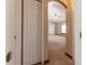 View from hallway highlighting closet and carpeted bedroom with ceiling fan and window at 13645 Se 42 Ave, Summerfield, FL 34491