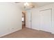 Bright bedroom featuring a ceiling fan, neutral carpet, and a closet for ample storage at 13645 Se 42 Ave, Summerfield, FL 34491