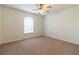 Carpeted bedroom with window featuring blinds, ceiling fan and neutral wall color at 13645 Se 42 Ave, Summerfield, FL 34491