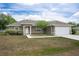 Charming single-story home with a well-manicured lawn, inviting entrance, and attached two-car garage at 13645 Se 42 Ave, Summerfield, FL 34491