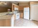 Well-equipped kitchen with modern appliances, ample counter space, and tile flooring for easy maintenance at 13645 Se 42 Ave, Summerfield, FL 34491