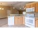 Bright kitchen featuring stainless steel appliances, tile flooring, and light wood cabinetry at 13645 Se 42 Ave, Summerfield, FL 34491
