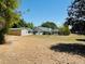 Expansive backyard featuring a detached garage and lush greenery, perfect for outdoor activities at 15069 Se 73Rd Ave, Summerfield, FL 34491