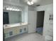 Bright bathroom featuring a double sink vanity with ample counter space and tiled floors at 15069 Se 73Rd Ave, Summerfield, FL 34491