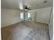 Carpeted bedroom with ceiling fan, ample natural light, and a connecting doorway to another room at 15069 Se 73Rd Ave, Summerfield, FL 34491