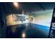 View of garage showcasing storage shelves, ceiling fan, track lighting and painted floor at 15069 Se 73Rd Ave, Summerfield, FL 34491