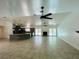 Bright, open living area with tile flooring, a ceiling fan, fireplace, and sliding doors to the backyard at 15069 Se 73Rd Ave, Summerfield, FL 34491