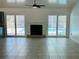 Cozy living room with a fireplace and sliding glass doors leading to a screened-in pool area at 15069 Se 73Rd Ave, Summerfield, FL 34491