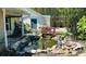 Charming pond featuring a red bridge, lush plants, and a serene ambiance that enhances the landscape at 15069 Se 73Rd Ave, Summerfield, FL 34491