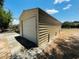 Exterior view of a metal shed with a roll-up door at 15069 Se 73Rd Ave, Summerfield, FL 34491