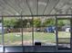 View of the large backyard from the screened porch with fencing and mature trees at 15976 Sw 23Rd Court Rd, Ocala, FL 34473