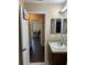 Hallway view to bathroom with vanity and decorative mirror at 15976 Sw 23Rd Court Rd, Ocala, FL 34473