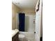 Bathroom with shower-tub combo, blue shower curtain and white fixtures at 15976 Sw 23Rd Court Rd, Ocala, FL 34473