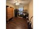 Bedroom with wood-look floors, ceiling fan, chest, gun safe and table at 15976 Sw 23Rd Court Rd, Ocala, FL 34473
