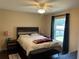 Relaxing bedroom with a decorative headboard, ceiling fan, and plenty of natural light at 15976 Sw 23Rd Court Rd, Ocala, FL 34473