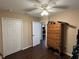 Bedroom with wood-look floors, ceiling fan, chest, and closet at 15976 Sw 23Rd Court Rd, Ocala, FL 34473