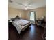 Well-lit bedroom featuring a bed, nightstand, desk, and overhead fan at 15976 Sw 23Rd Court Rd, Ocala, FL 34473