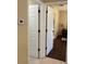 Neutral hallway featuring white doors and tile flooring leading to an open room at 15976 Sw 23Rd Court Rd, Ocala, FL 34473